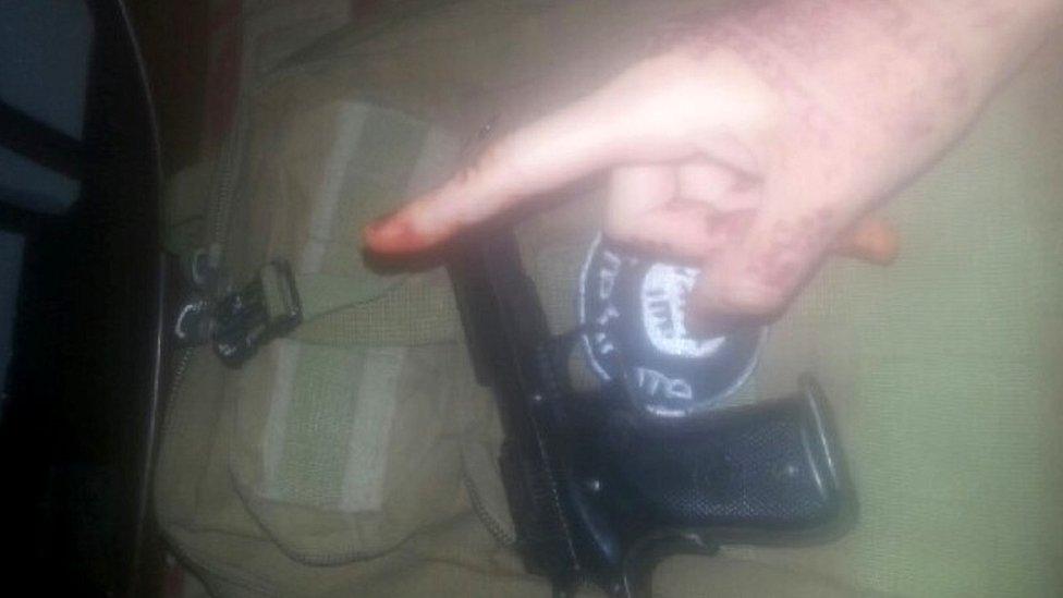 An image of a hand and a gun