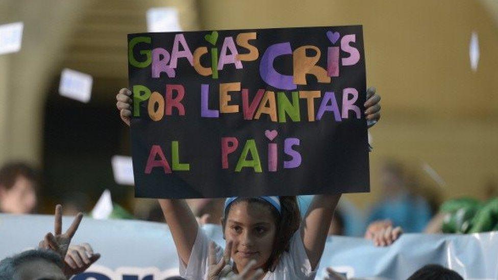 A girl holds a sign reading "Thanks Cris for lifting the country" (file image)