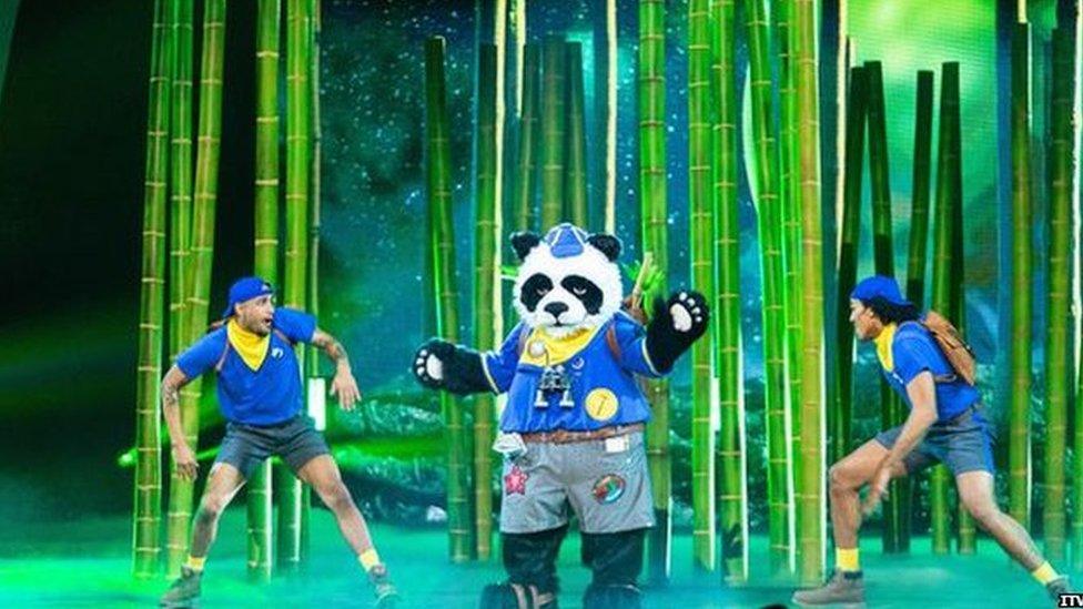 A photo of Panda and back up dancers on The Masked Singer