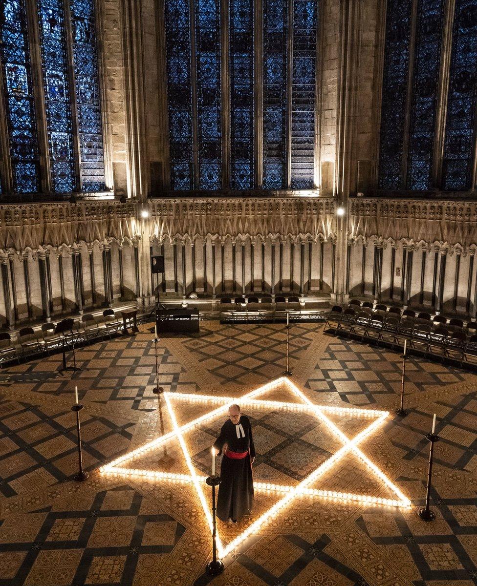 The Reverend Canon Michael Smith, Acting Dean of York, helps light six hundred candles in the shape of the Star of David, in the Chapter House at York Minster in York, part of York Minster's commemoration for International Holocaust Day