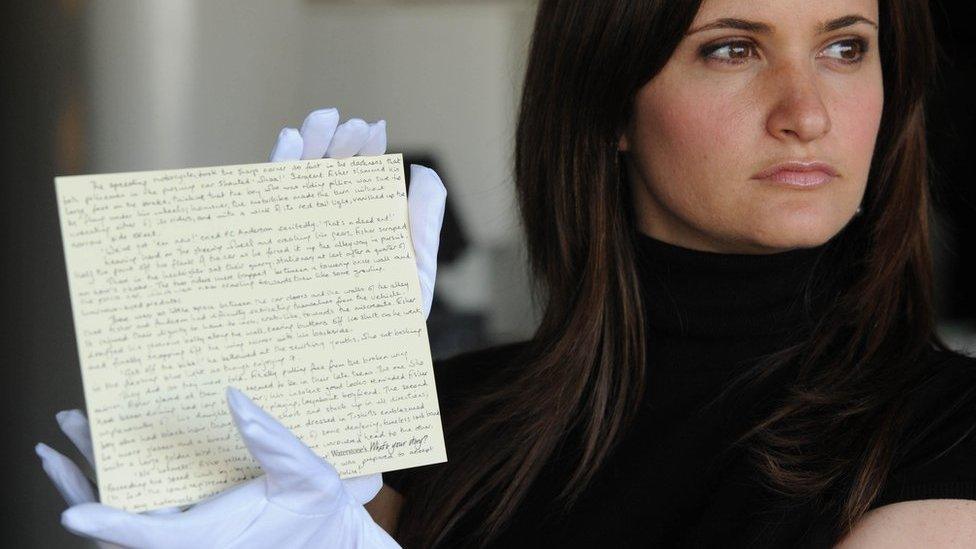 10/06/08 A worker at Waterstones holding the manuscript