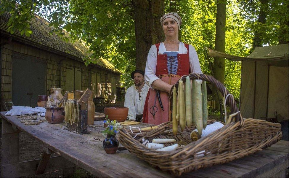 re-enactors making candles