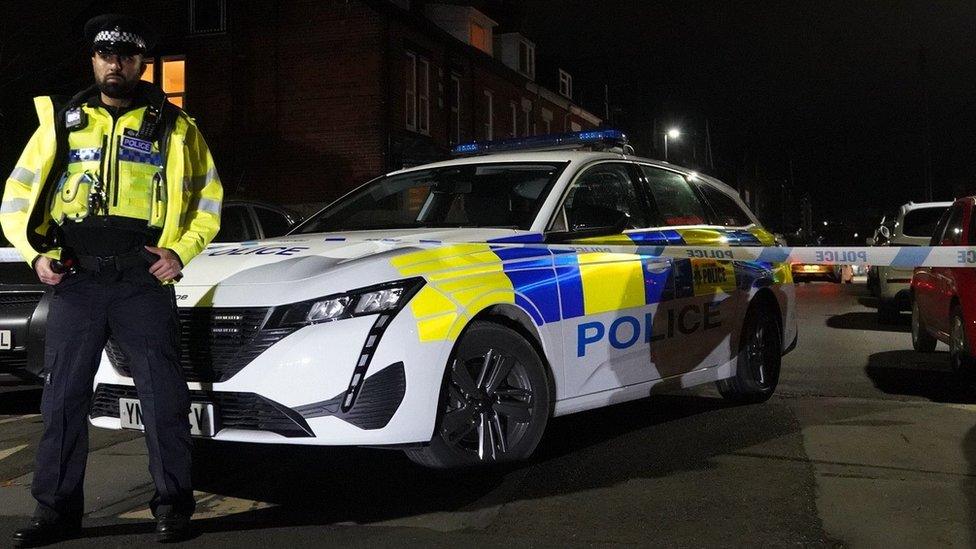 Police stands guard by the car