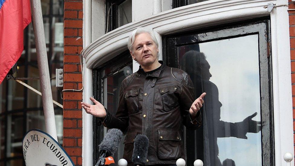 Julian Assange stands on the balcony of the Ecuadorian embassy in London.