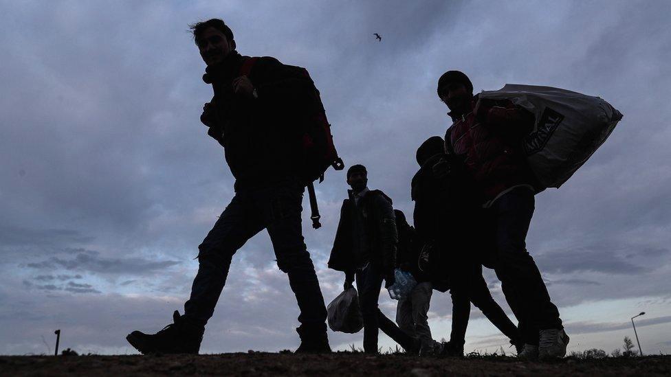 A group of migrants and refugees walk to Pazarkule Border gate during the sunset at the city centre of Edirne, Turkey, 04 March 2020.