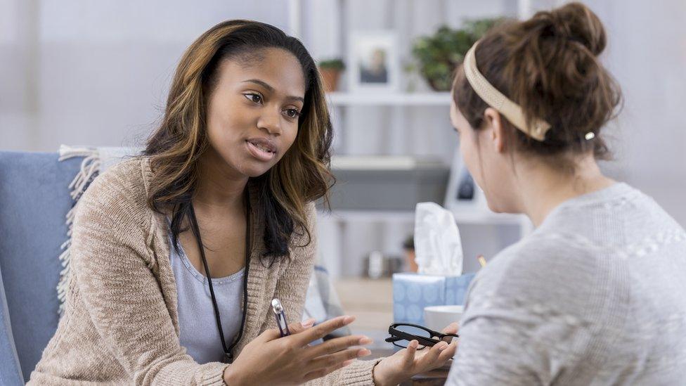 Doctor speaking to an anonymous patient