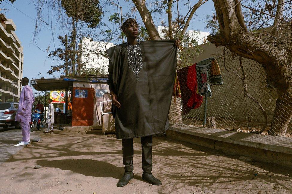 Same Ama Faye poses in a black boubou