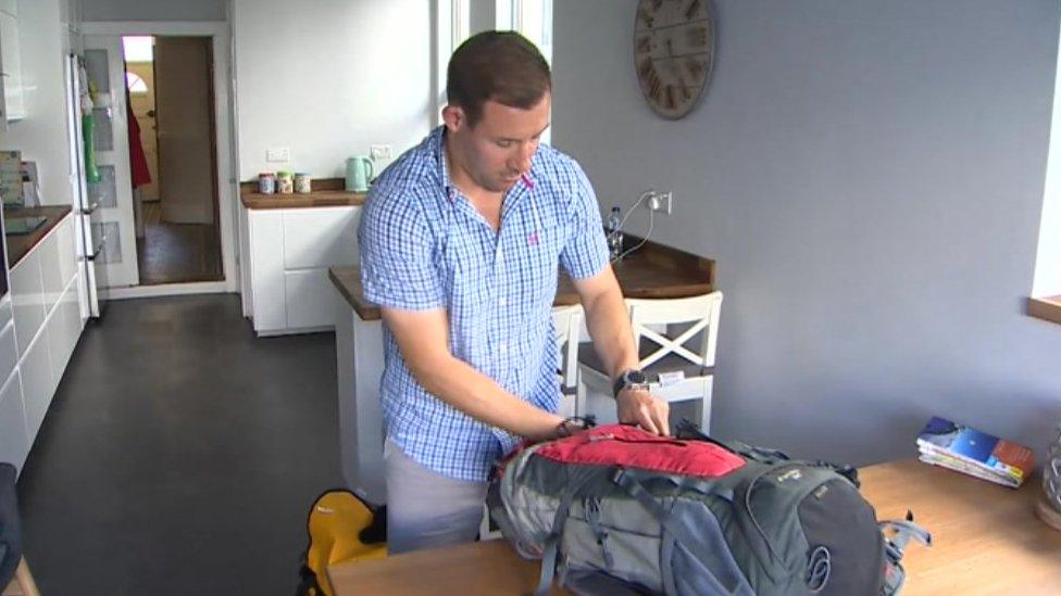 Gareth Hopkins packing his suitcase