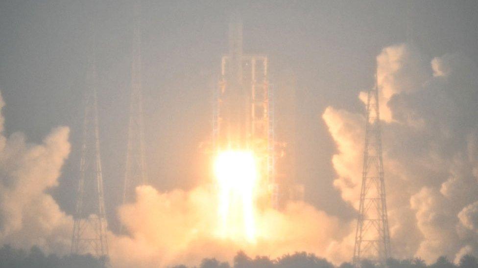 A Long March 5 rocket, carrying the Chang'e-6 mission lunar probe, lifts off as it rains at the Wenchang Space Launch Centre in southern China's Hainan Province