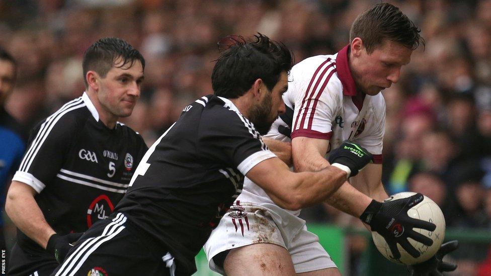 Kilcoo's Niall Branagan attempts to win the ball from Se McGuigan of Slaughtneil