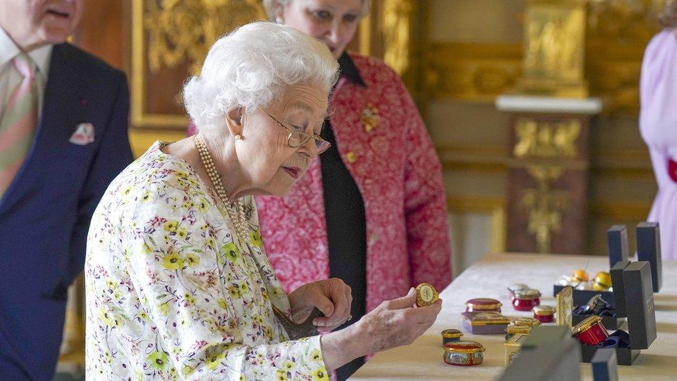 Queen Elizabeth II views a selection of hand-decorated archive enamelware