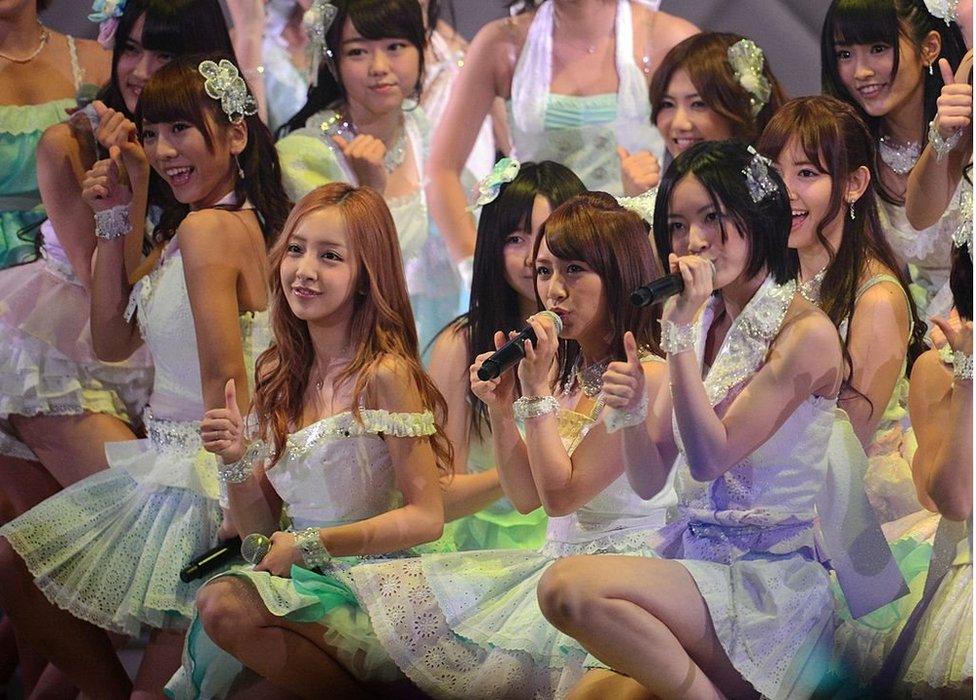 Members of girl band AKB48 perform on stage during an event to select which of them will get to perform the band's 27th song, in Tokyo on 6 June 2012.