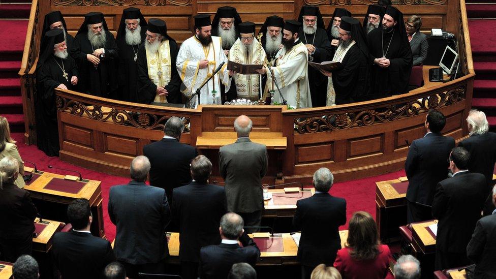 Orthodox priests conduct a blessing ceremony of the Greek parliament for the winter season in Athens on October 7, 2013