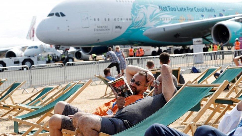 spectators relax in deckchairs