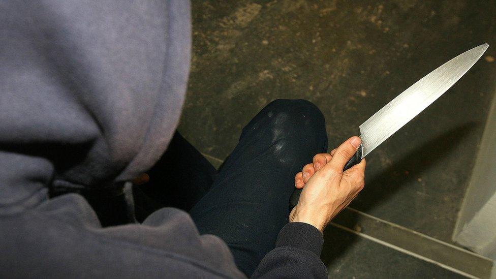 Generic picture of a young man holding a knife