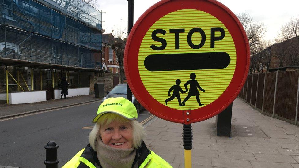 Lady poses with sign