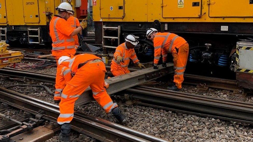 Engineers working on derailed train