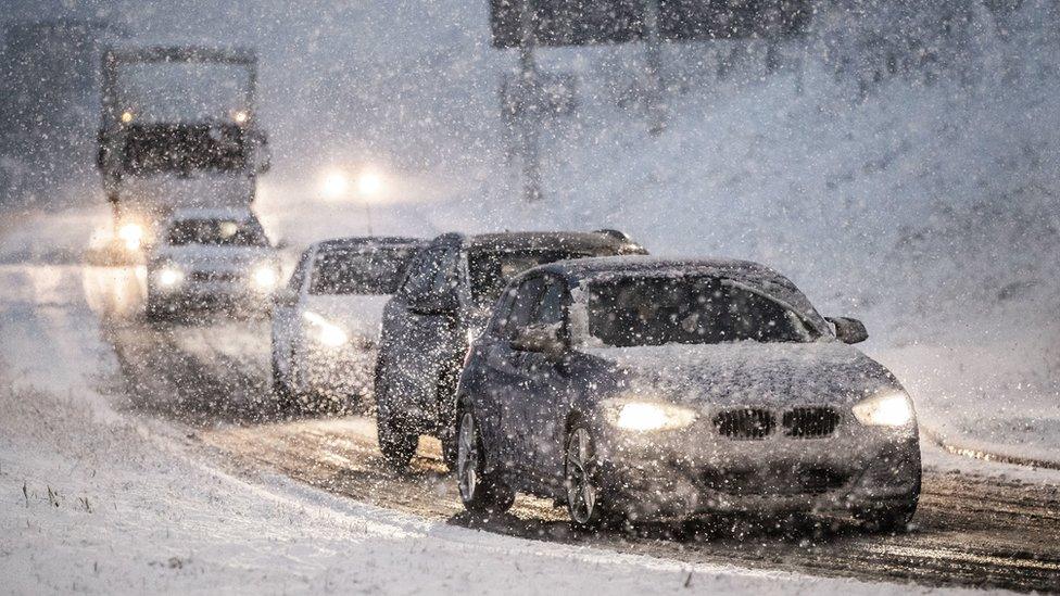 Cars drive in snow