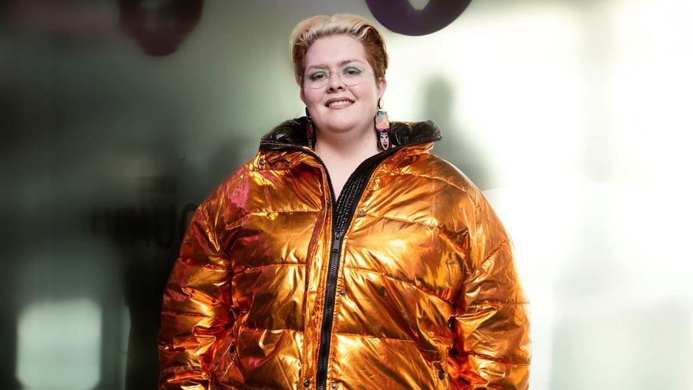 Jayde Adams wearing a big copper coloured puffa jacket