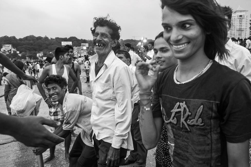 Men laughing while celebrating Ganesh Chaturthi, a Hindu festival