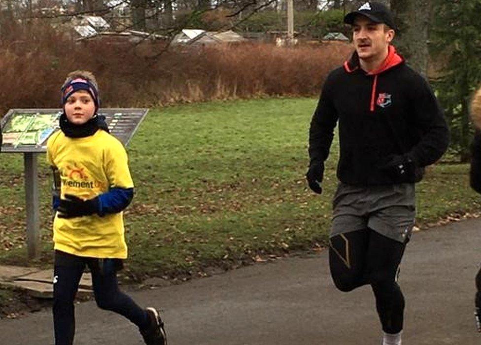 Rory Logg running with Scotland 7s rugby player Ross McCann