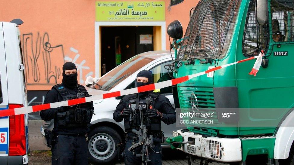 Police stand in front of Al-Irschad Mosque during a raid on April 30, 2020 in Berlin