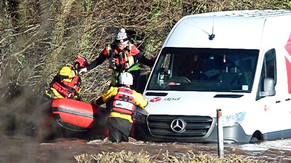 Emergency services rescue a DPD delivery van driver stranded in flood water in Newbridge on Usk