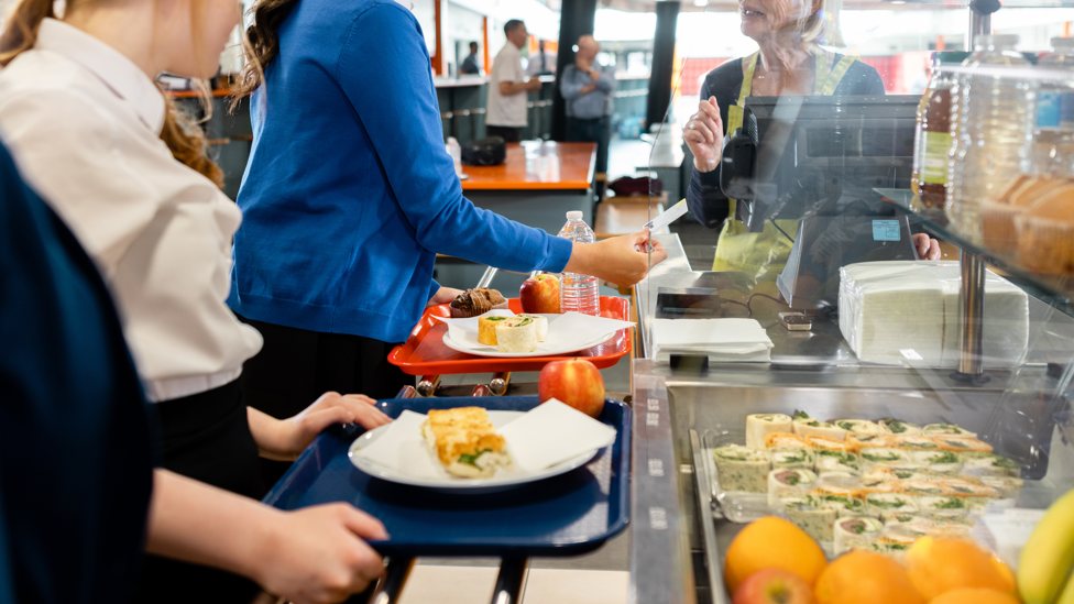 Children being served in a school canteen