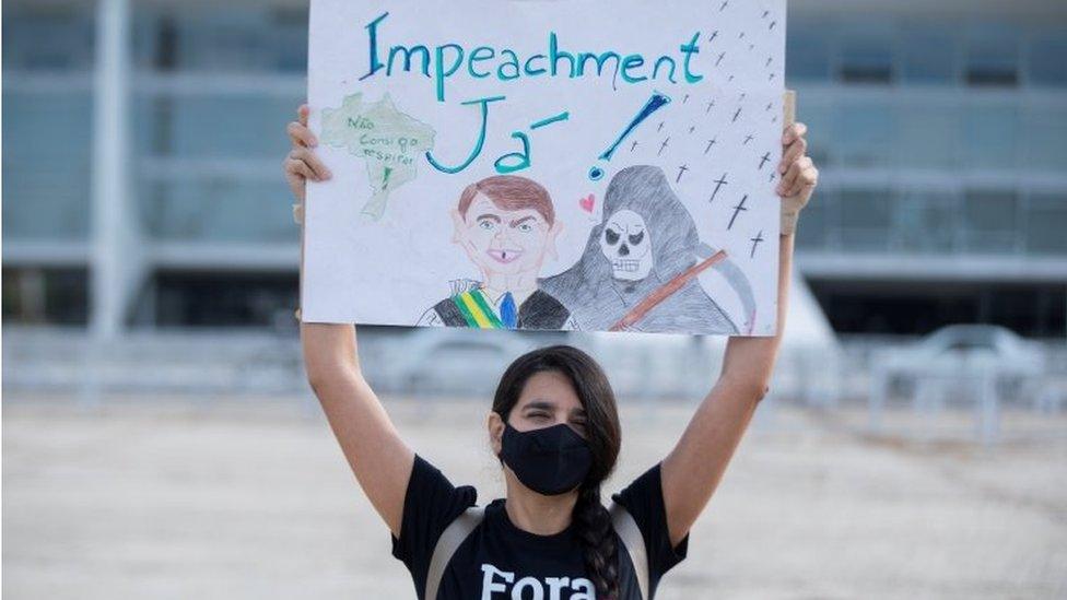 A woman demonstrates against the pandemic management by Brazilian President Jair Bolsonaro, in Brasilia, Brazil, 26 March 2021