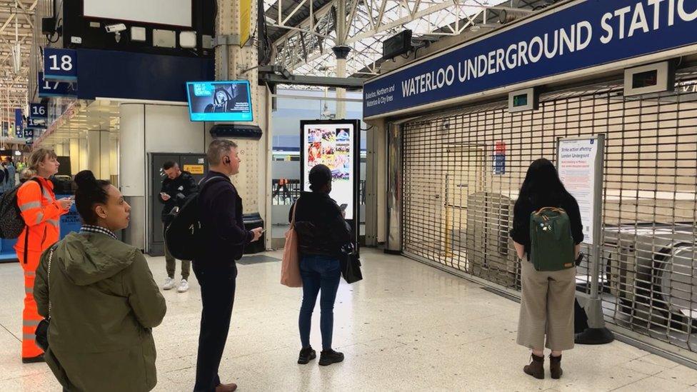 Passengers look at closed gates