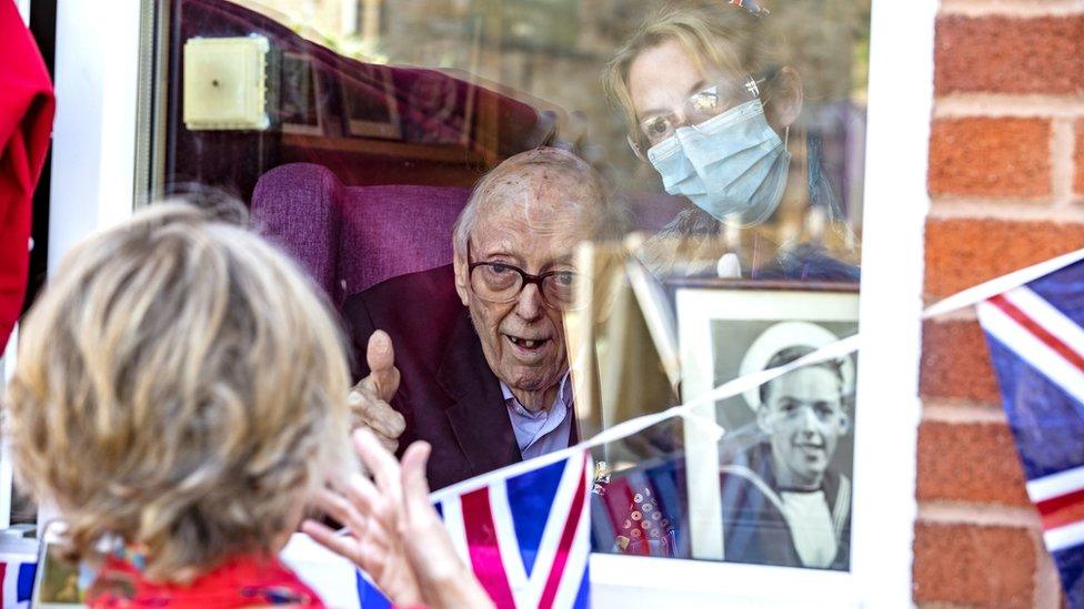 Second World War veteran Signalman Eric Bradshaw, who has tested positive for Covid-19, holds his thumbs up as he celebrates VE Day