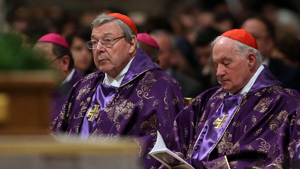 Cardinal George Pell (l) listens to a mass, while sitting among other cardinals at St Peter's Basilica on February 10, 2016 in Vatican City