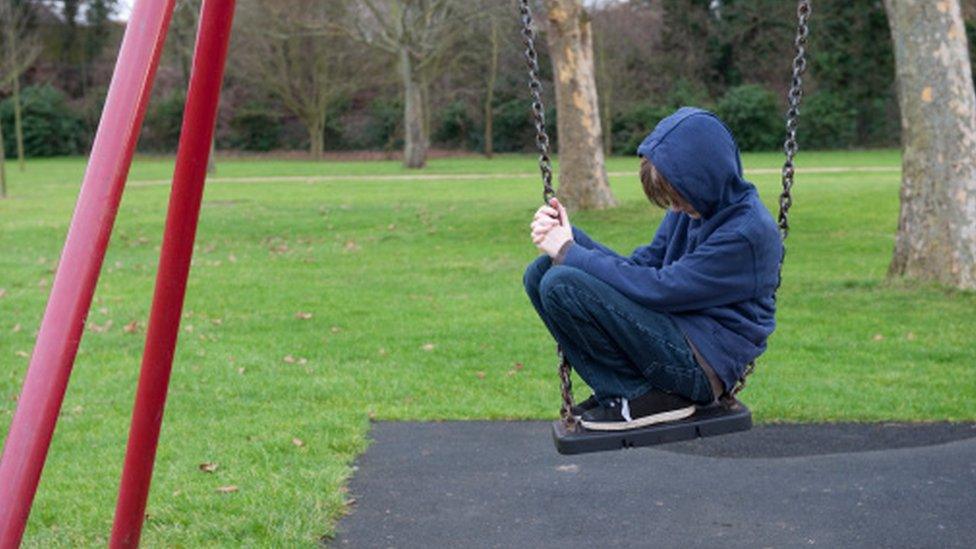 A sad child on a swing