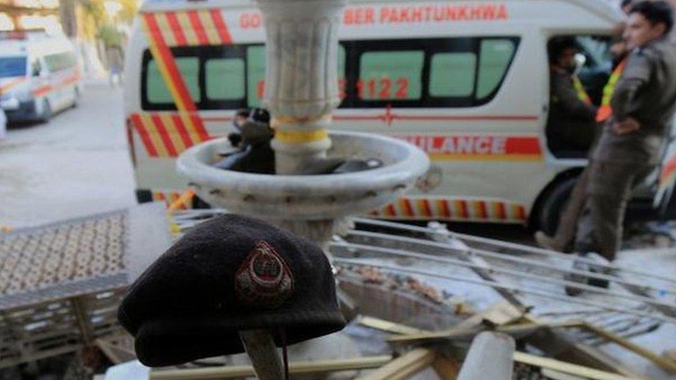 A police beret (C) among debris at the scene a day after a suicide bomb blast at a Mosque in Police Lines, in Peshawar