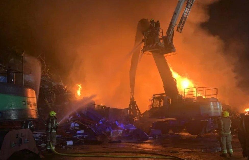 Fire burning at a scrapyard