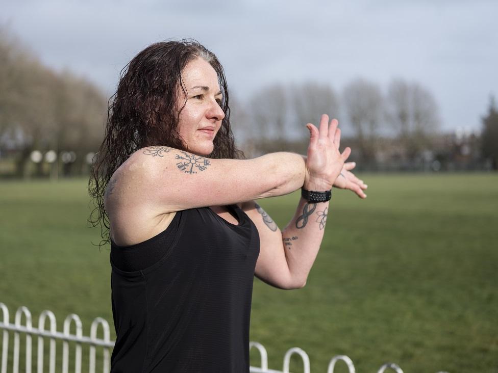 Michelle Bavin stretching before a run