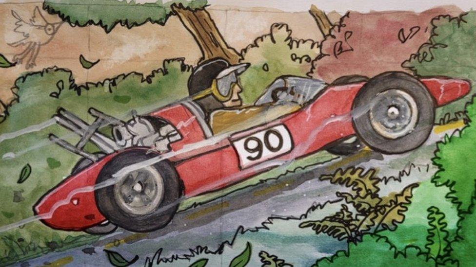 A driver races up a road in a red car taking part in the Pontypool Hill Climb