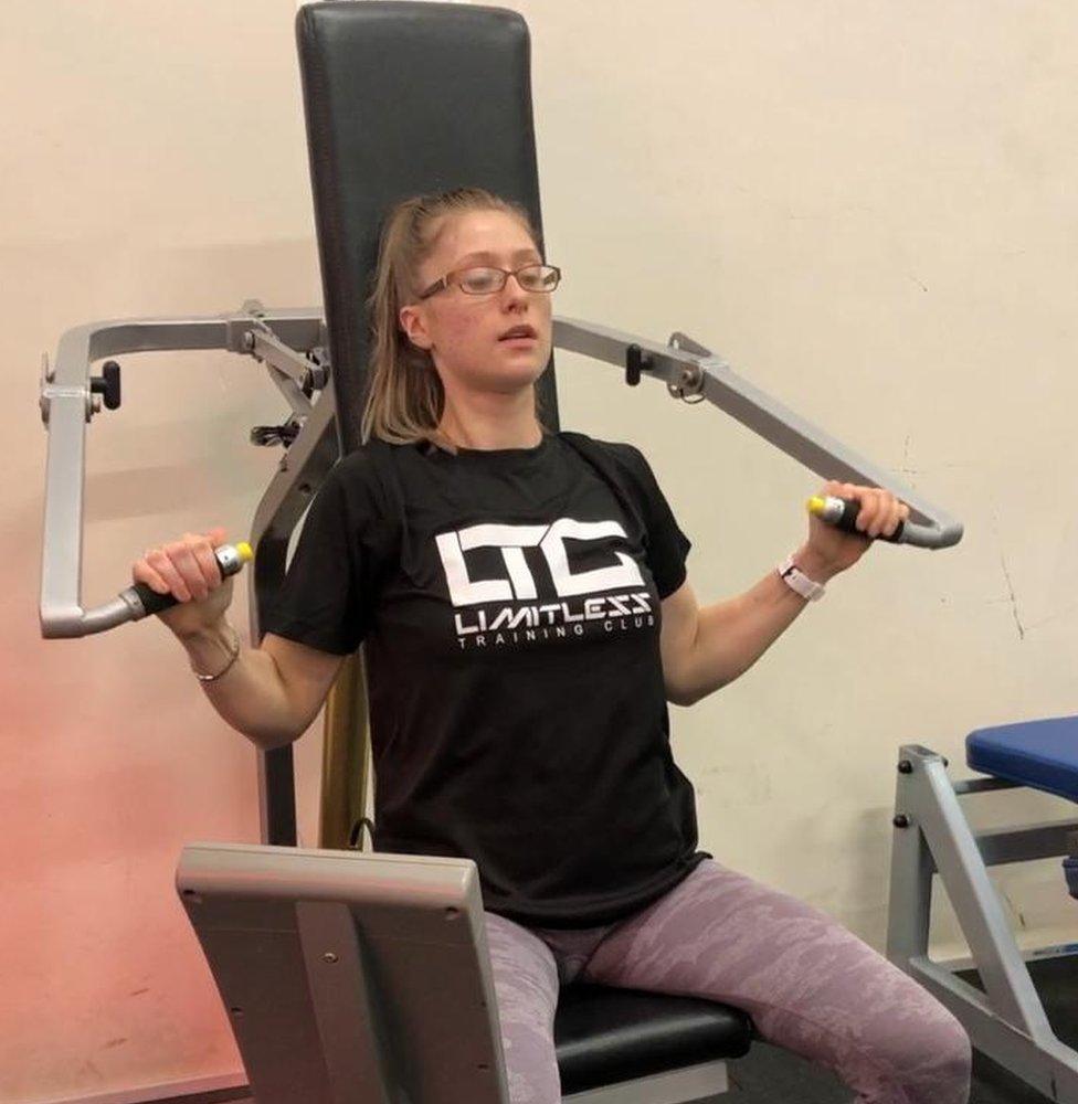 Megan is pictured using a machine at the gym