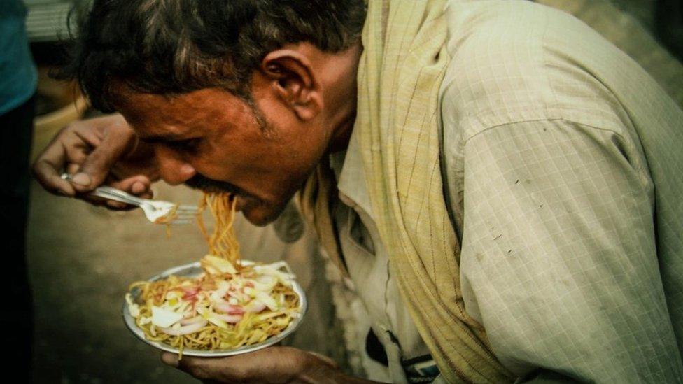 Man eating noodles