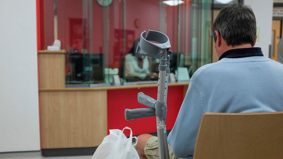 A man waiting in an accident and emergency department