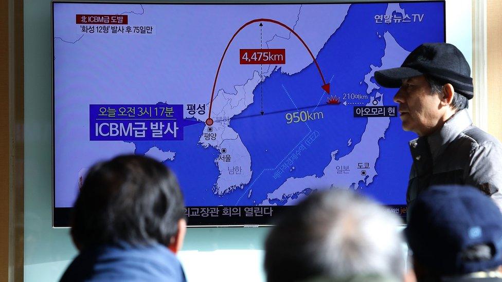 People in Seoul watch a TV report about the missile launch, 29 November