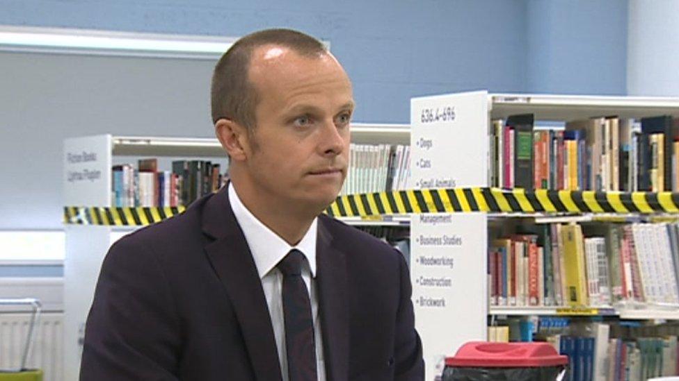 Matt Williams in front of a book shelf