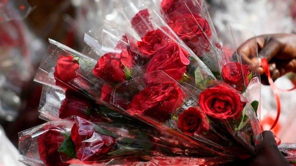 Bouquets of roses are for sale for Valentine's Day at a flower shop