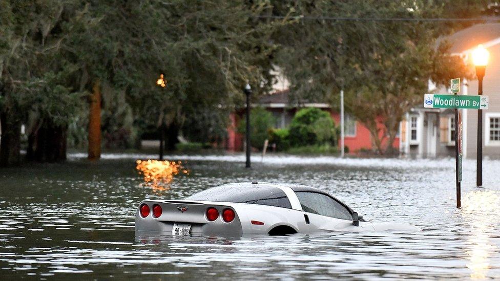 a car underwater along a flooded road in Florida