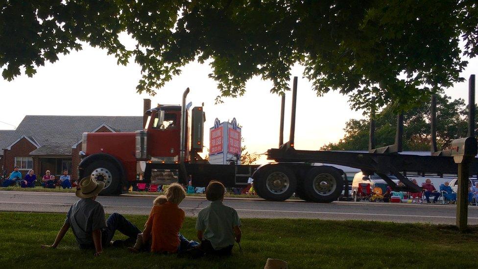 Amish watching truck parade