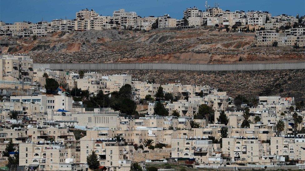 View of Israeli barrier separating the Jewish settlement of Neve Yaakov (foreground) and the Palestinian area of al-Ram in the occupied West Bank (27 January 2020)