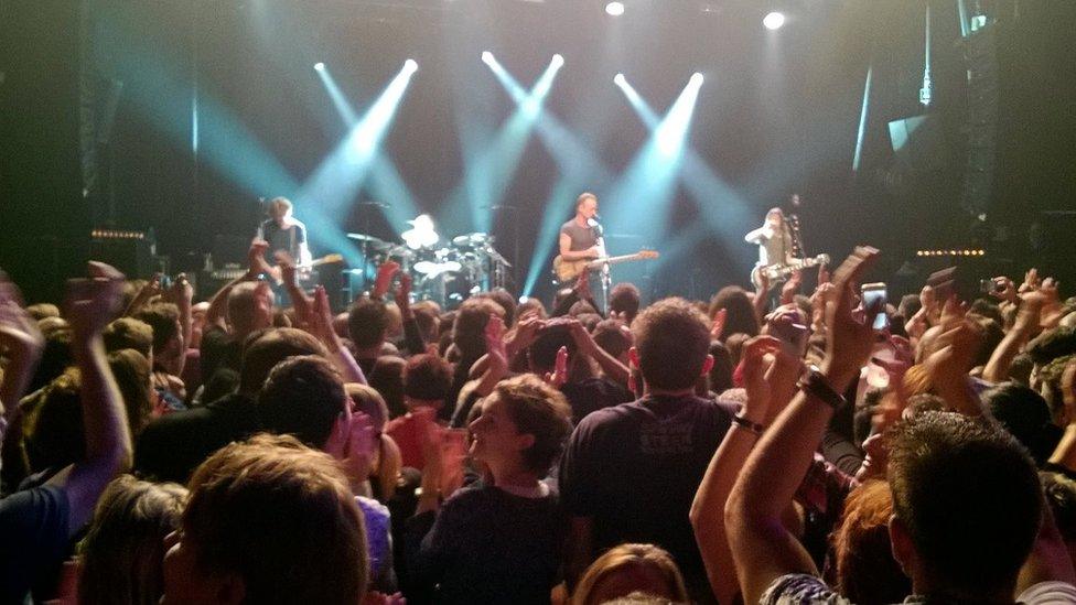 People watch British musician Sting perform at the Bataclan concert hall in Paris