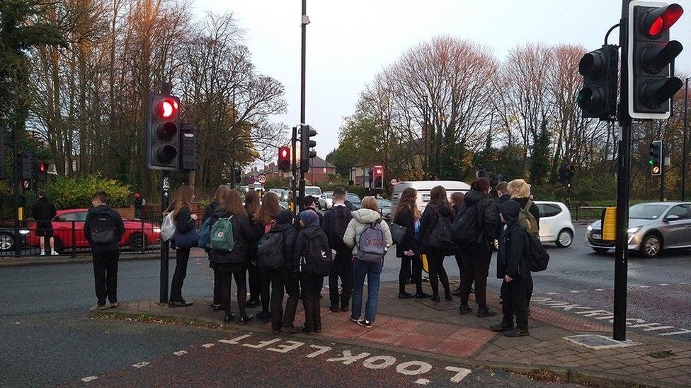 School children waiting to cross the Coast Road