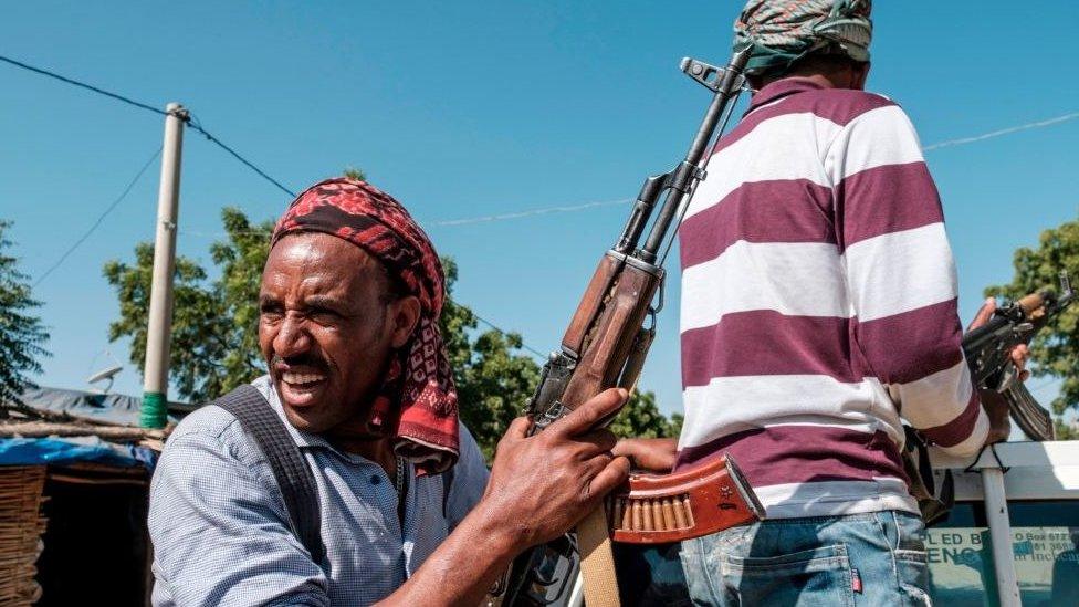 Members of the Amhara militia ride in the back of a pick up truck, in Mai Kadra, Ethiopia, on November 21, 2020. - Amharas and Tigrayans were uneasy neighbours before the current fighting, with tension over land sparking violent clashes. That Mai-Kadra is now being run,at least temporarily, by Amharas provides relief to Amharas, even as it deepens Tigrayan fears of occupation. (Photo by EDUARDO SOTERAS / AFP) (Photo by EDUARDO SOTERAS/AFP via Getty Images)