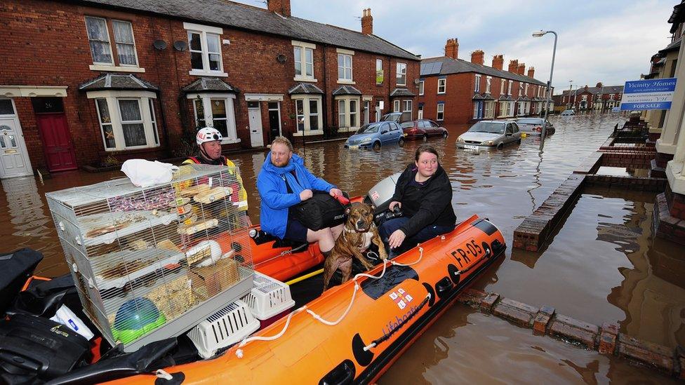 Sophie Thornton and Chris Fairclough with their dog, two cats and a chinchilla are rescued from their flooded home